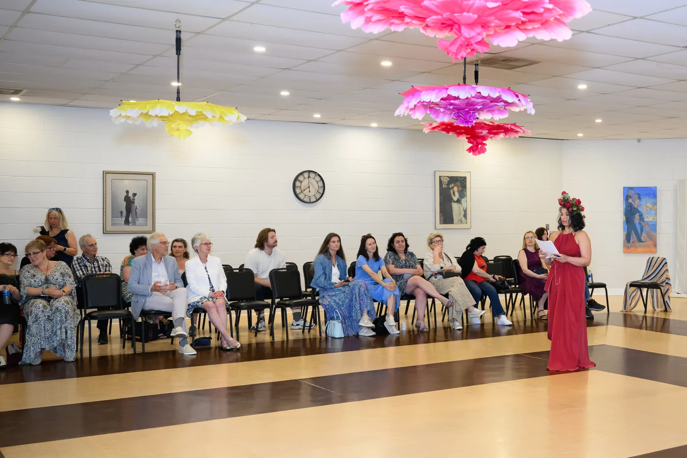 Guests seated for the runway presentation beneath the show's floral installations